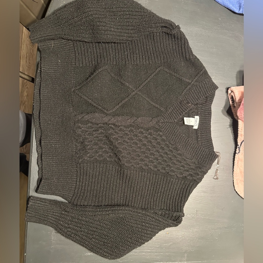 BLACK rue 21 sweater picture color looks grey. It is black